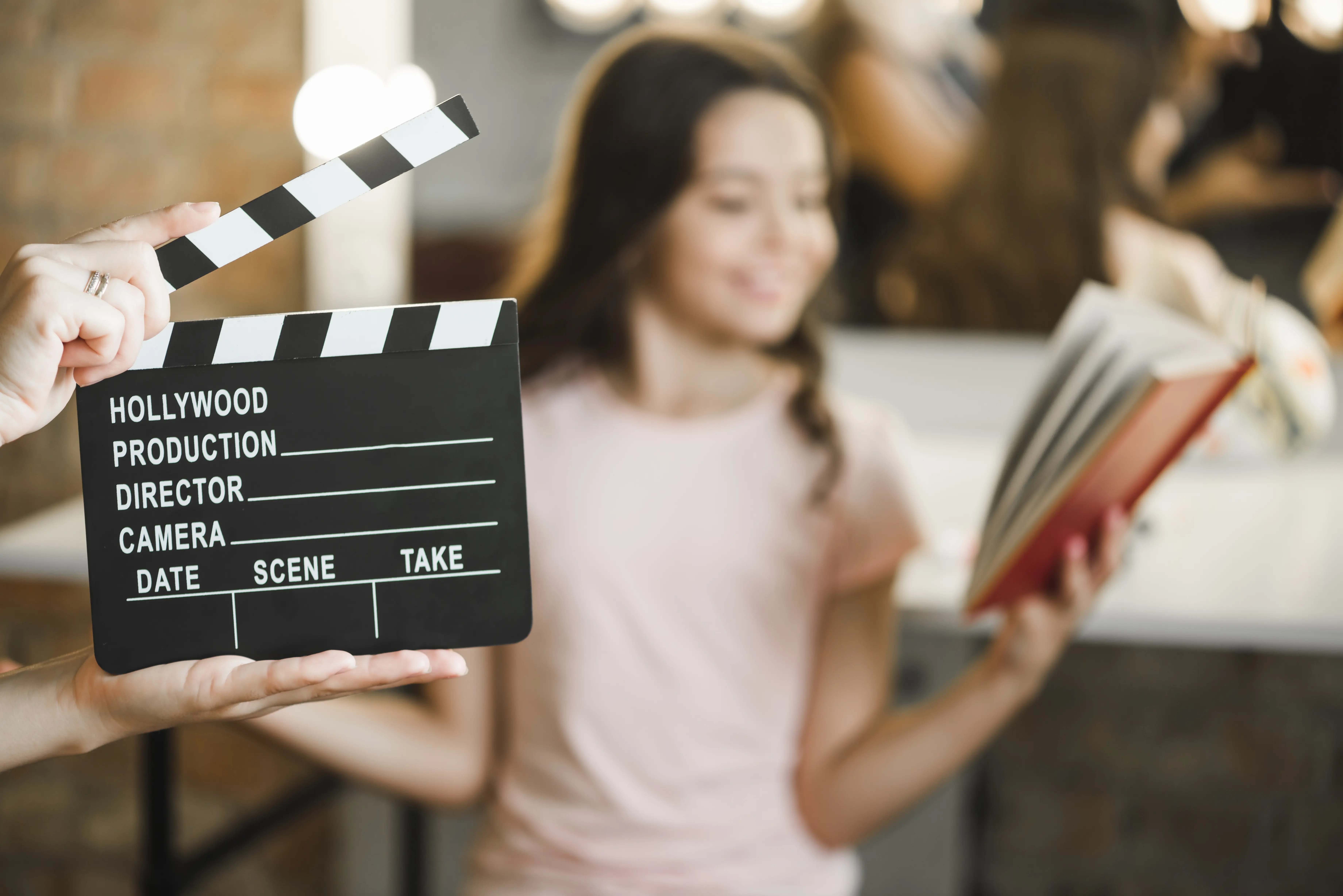 close up person holding clapper board front girl rehearsing 1